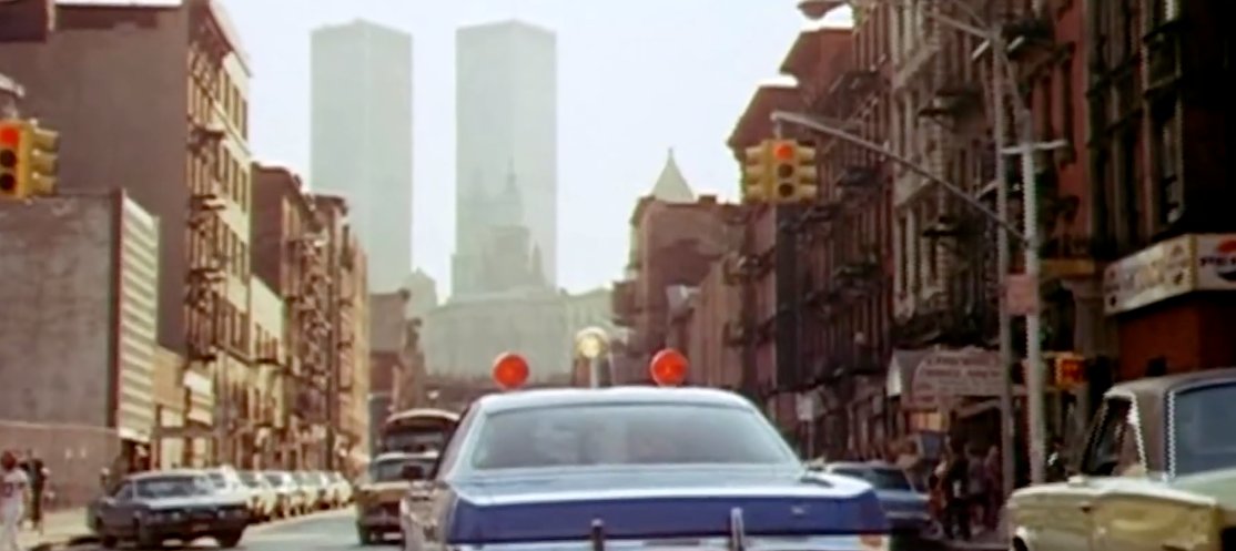 Law and Disorder (1974): skyline cameo of the World Trade Center, both towers (no antenna)